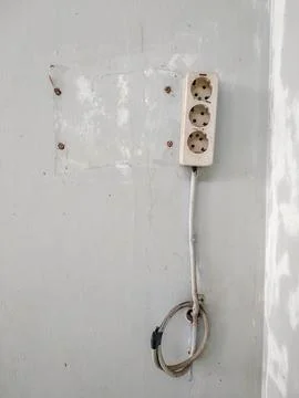 Electrical socket in grey wall Stock Photos