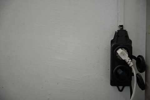 Electrical socket isolated on white wall. Empty copy space single white plastic Stock Photos