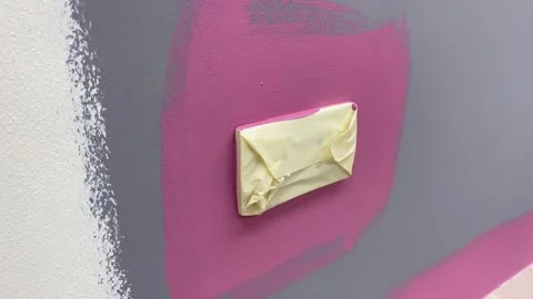 Electrical socket plug power supply cover with white tape painted wall. Stock Footage 249806233