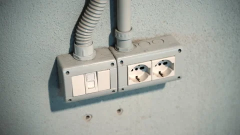 Electrical socket plugs and switch on outer wall, plastic fix boxes with two Stock Footage 250484734
