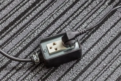 Electrical socket with power plug cable on carpet floor for safety concept Stock-Fotos