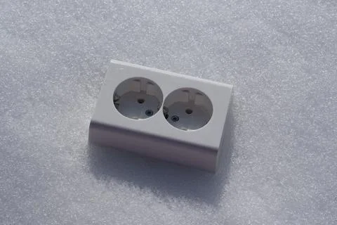 Electrical socket on the snow close-up. Foto stock