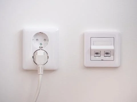 Electrical sockets on the wall with black connection internet plug and white  Stock Photos