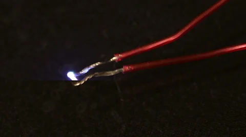 Electrical spark between two insulated wires. Electric arc Video stock 68421364