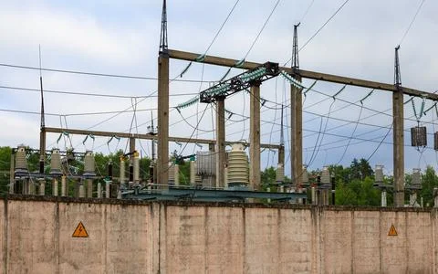 Electrical substation and high voltage power grid infrastructure behind con.. Stock Photos