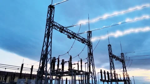 Electrical substation with bright energy arcing along high voltage power lines Stock Footage 332873922