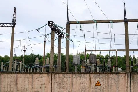 Electrical substation. High voltage power grid infrastructure stand behind .. Stock Photos