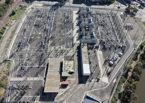 Electrical substation infrastructure transmitting power grid energy aerial view Stock Photos