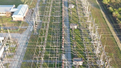 Electrical substation: transformers and grid of pylons, lines and wires Stock Footage 152053902