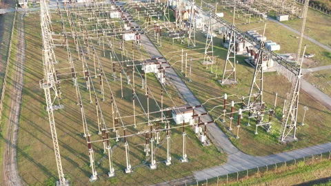 Electrical substation: transformers and grid of pylons, lines and wires Stock Footage 152056422