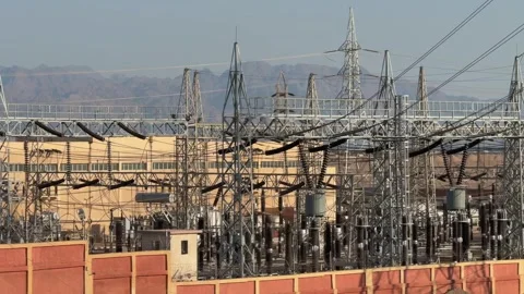 Electrical substation with transformers and high voltage structures in desert Stock Footage 341837784