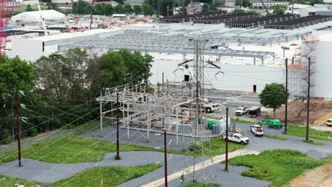 Electrical substation under construction stands beside data center in Stock Footage 337978488