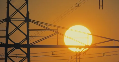 Electrical Sunset: Sun Setting Amidst High-Voltage Lines Stock-Footage 276325790