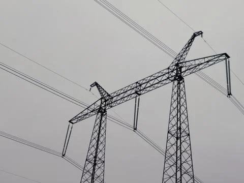 Electrical support on gray sky background Stock Photos