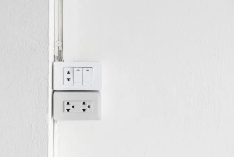 Electrical switch and plug on wall Stock Photos