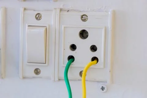 Electrical switch and socket with colorful wires connected Stock Photos
