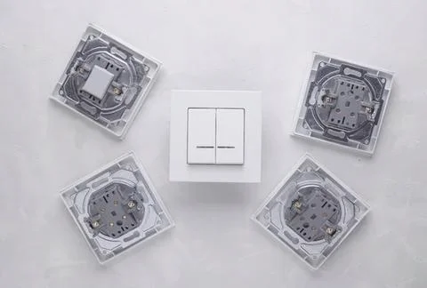 Electrical switch with four socket adapters on white surface Stock Photos