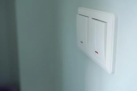 Electrical switch on the wall. Light switch on the wall. Stock Photos