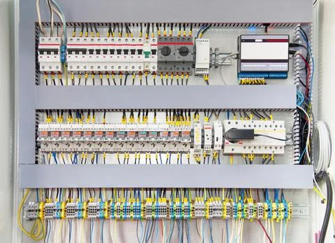 Electrical switchboard with different colored wires, switches and sensors Stock Photos