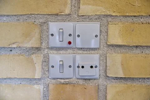 Electrical Switches and Socket on Brick Wall Stock Photos