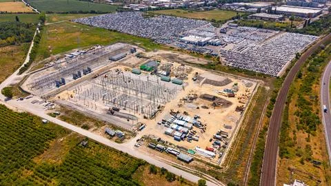 Electrical switchyard beside railway tracks, aerial view. Metal frames and .. Stock Photos