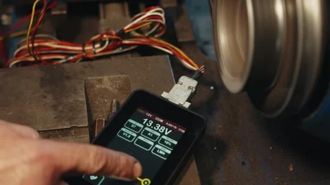 Electrical test bench ammeter and hand presses buttons on display changing Stock Footage 285642676