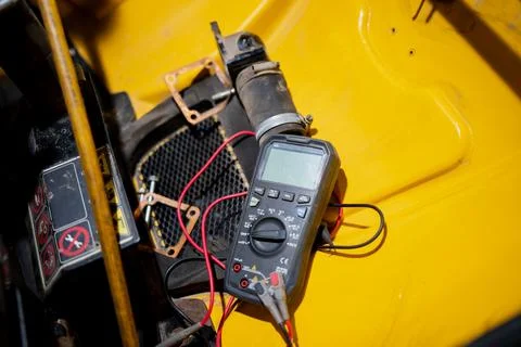 Electrical testing instrument on construction machine representing repairs Stock Photos