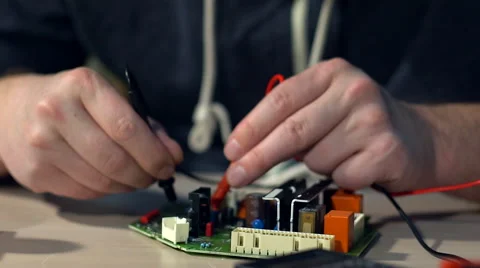 Electrical is testing with voltmeter for repair electronic equipment Stock Footage 69030988