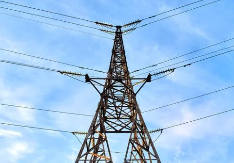 Electrical tower on the blue cloudy sky background, symmetrical background Stock Photos