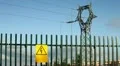 Electrical tower on blue sky with yellow personalized warning signboard HD Footage