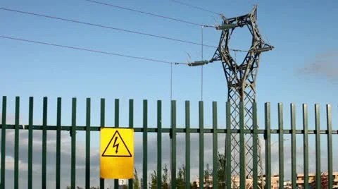 Electrical tower on blue sky with yellow personalized warning signboard Stock Footage 10902817
