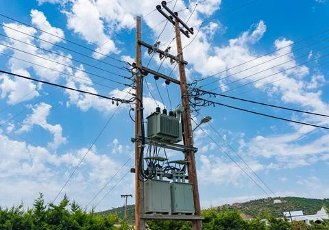 Electrical transformer mounted on a street pole against the sky Stock Photos