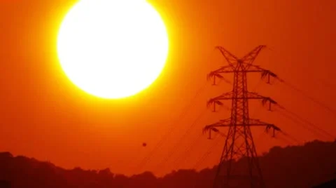 Electrical transmission tower at sunset Stock Footage