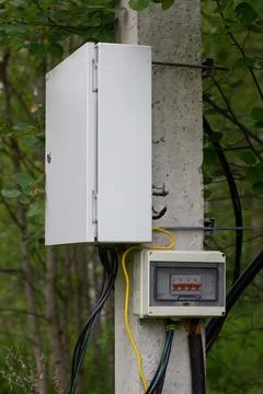 Electrical Utility Boxes On A Concrete Pole Stock Photos