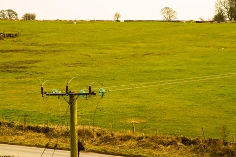 Electrical Utility pole with insulators Stock Photos