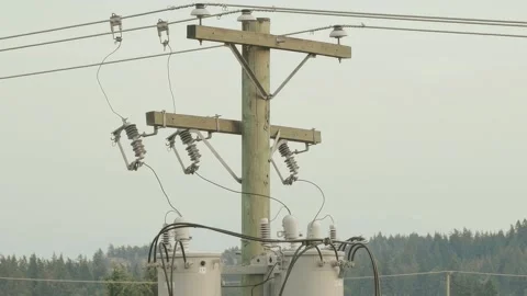 Electrical utility pole overhead distribution transformers and power lines Video stock 342677731