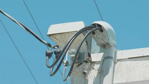 Electrical weatherhead service mast connection on building roof Stock Footage 337788889
