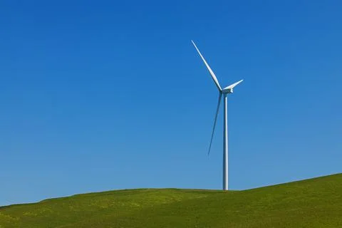 Electrical wind power mill over the blue sky. Stock Photos