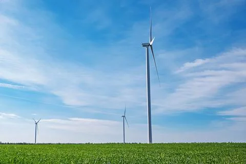 Electrical wind power mills over the blue sky Stock Photos