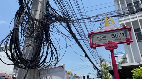 Electrical wire cable on pole near alley sign on street sunny blue sky, Thailand Stock Footage 252160971
