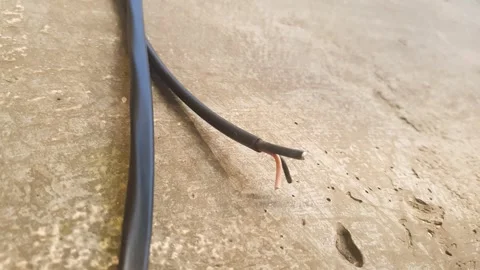 An electrical wire on a concrete wall. Electrical wiring installation Stock Footage 347404883