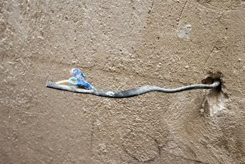 Electrical wire in plaster, on the wall, rough finish with wire for socket,.. Stock Photos