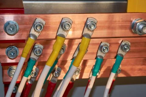 Electrical wires are connected to copper busbars. Stock Photos
