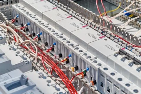 Electrical wires are connected to modular contactors. Stock Photos