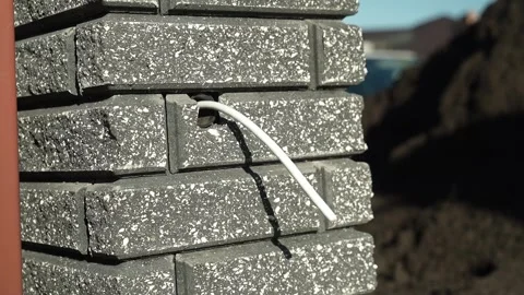 Electrical Wires are pulled out of the brick wall Stock Footage 261178250