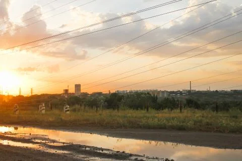 Electrical wires on the background of the sunset sky Stock Photos