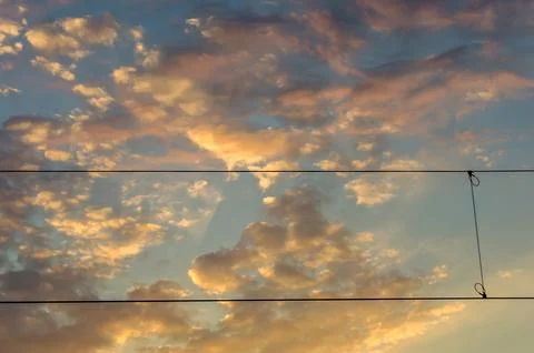 Electrical wires on cloudy sky background Stock Photos