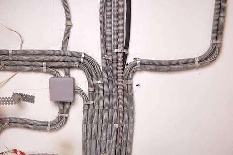 The electrical wires in the protective corrugated cable tube and the juncti.. Stockfoto's