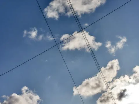 Electrical wires in sky background. Cloudy sky. Stock Photos