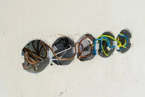 Electrical wiring connections inside wall junction boxes during construction Foto stock